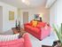 Carpeted living room furnished with a couch and upholstered chair at Valley Stream Apartments in Lansdale, PA.