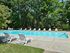 Community pool with lounge chairs at Valley Stream Apartments in Lansdale, PA.