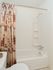 White tiled shower and tub in Shillington, PA apartment bathroom