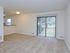 Carpeted living room with sliding glass patio doors at Willow Ridge Apartments in Marlton, NJ.