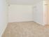 Living room with beige carpets and closet doors at Boothwyn Court apartments for rent