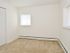 Bedroom with windows and baseboard heating at Boothwyn Court apartments for rent