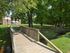 Walking path over creek to landscaped grounds of Glen Eagle Village Apartments