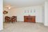 Carpeted living room with dining area at Naamans Village Apartments in Claymont, DE.