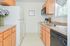 Model kitchen with tiled flooring, wood cabinets and modern appliances at Wyntre Brooke apartments in West Chester, PA.