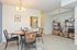 Model dining area furnished with a circular table and 4 chairs at Wyntre Brooke apartments in West Chester, PA.