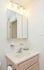 Model bathroom with vanity sink and lighted mirror at Wyntre Brooke apartments in West Chester, PA.