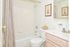 Model bathroom with vanity sink, toilet and tub shower at Wyntre Brooke apartments in West Chester, PA.