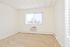 Carpeted main bedroom with large windows and in-wall A/C unit at Norriton East Apartments in East Norriton, PA.