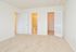 Carpeted main bedroom with a walk-in closet and attached bathroom at Norriton East Apartments in East Norriton, PA.