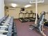 Fitness center with dumbbells, treadmills, cable machine, and bench at Gayley Park apartments for rent in Media, PA