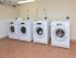 Community laundry center with washers and dryers at Gayley Park apartments in Media, PA