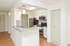 Model kitchen with breakfast bar and stainless-steel appliances at The Lafayette at Valley Forge apartments in King of Prussia, PA.