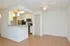 Model kitchen with wood-style flooring, breakfast bar and dining area at The Lafayette at Valley Forge apartments in King of Prussia, PA.