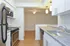Model kitchen with breakfast bar and stainless-steel appliances at The Lafayette at Valley Forge apartments in King of Prussia, PA.