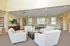 Community center lounge area 4 upholstered chairs at The Lafayette at Valley Forge apartments in King of Prussia, PA.