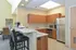 Community center kitchen with bar seating at The Lafayette at Valley Forge apartments in King of Prussia, PA.