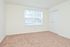 Carpeted bedroom with a large window at Willow Run Apartments in Willow Grove, PA.