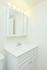 Model bathroom with lighted vanity sink at Willow Run Apartments in Willow Grove, PA.
