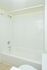 Model bathroom with tiled floors and a tub shower at Willow Run Apartments in Willow Grove, PA.