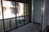 Giant private patio with metal railing and sliding glass doors
