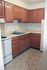 Kitchen with brown cabinets and classic flooring in Lansdale, PA apartment for rent