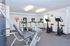 Fitness center with leg curl and leg extension machine at Cedar Tree Village apartments for rent