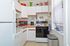Kitchen with appliances, brown and white cabinets, and countertops at Gilpin Place apartments for rent in Wilmington, DE