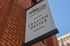 Leasing office sign attached to the exterior of the brick building at Waterloo Place Apartments in Baltimore, MD.