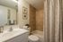 Bathroom with tiled shower and white tub in apartment for rent in Montgomery County, PA
