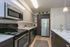 Renovated kitchen with modern cabinetry, stainless steel appliances, and hardwood floors