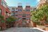 Paved courtyard with benches in front of the entrance to Waterloo Place Apartments in Baltimore, MD.