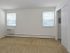 Living room with two windows at Concord Court apartments for rent in Aston, PA