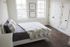 Sunny bedroom with large windows and hardwood flooring in apartment for rent in Kennett Square, PA
