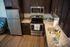 Contemporary kitchen with espresso cabinets and stainless steel appliances