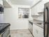 Kitchen with granite countertops and a window at Fox Run apartments for rent