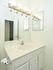 Quaint bathroom with white sink and vanity and large mirror