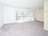 Huge sliding glass doors to private balcony letting in lots of natural light to spacious living area