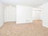 Spacious open layout of living and dining areas with beige carpet in apartment for rent in Newark, DE