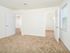 Spacious carpeted bedroom with large walk-in closet and window
