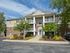 Glen Eagle Village leasing and management office with shrubs and blooming flowers out front