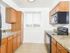 Kitchen with brown cabinets and black appliances at City View apartments for rent in Lancaster, PA