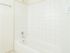 White tiled shower and tub in Newark, DE apartment bathroom