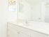 White bathroom sink and vanity with plenty of counter space and a large mirror