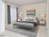 Carpeted bedroom with a large window is furnished with a large bed and 2 nightstands at Waterloo Place Apartments in Baltimore, MD.