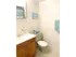 Model bathroom with tiled floors, vanity sink and toilet at Winslow House Apartments in Blackwood, NJ.