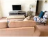 Model living room furnished with a couch, coffee table and upholstered chair at Winslow House Apartments in Blackwood, NJ.