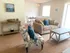 Model living room furnished with a couch, coffee table and upholstered chair at Winslow House Apartments in Blackwood, NJ.