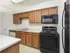 Kitchen with tile floors and modern appliances at Victoria Crossing Apartments in Reading, PA.