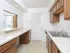 Kitchen with tile floors and modern appliances at Victoria Crossing Apartments in Reading, PA.